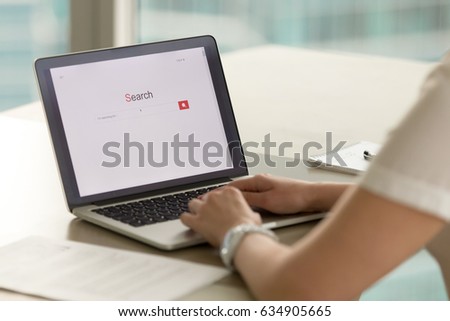 Womans hands typing on laptop searching information in Internet. Female office worker using online search service to find an answer or solution. Businesswoman surfing global network. Screen close up