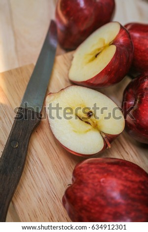 Apple red fruit Half cut on wooden floor.