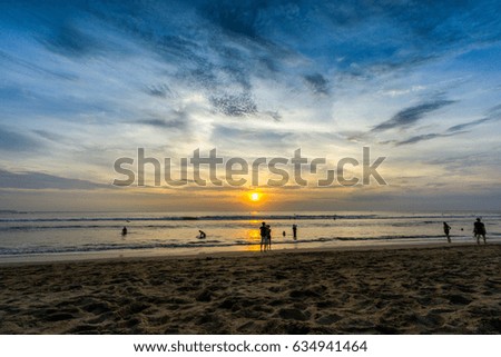 People enjoying sunset view at Kuta beach, Bali Indonesia