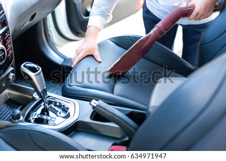 Remove dust with a vacuum cleaner during car cleaning/Car wash Royalty-Free Stock Photo #634971947