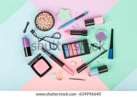 set of professional decorative cosmetics, makeup tools and accessory on multicolored background. beauty, fashion, party and shopping concept. flat lay composition, top view Royalty-Free Stock Photo #634996640