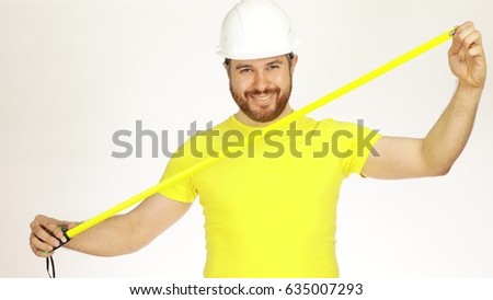 Happy construction engineer or architect in yellow tshirt and hard hat using measure tape against white background