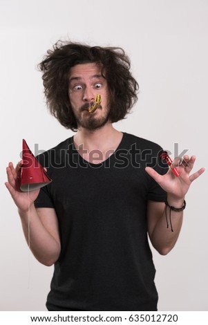 Portrait of a man in party hat blowing in whistle isolated on a white background