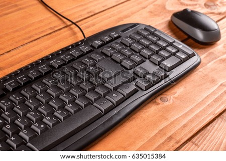 Closeup macro black pc keyboard with black wireless mouse.