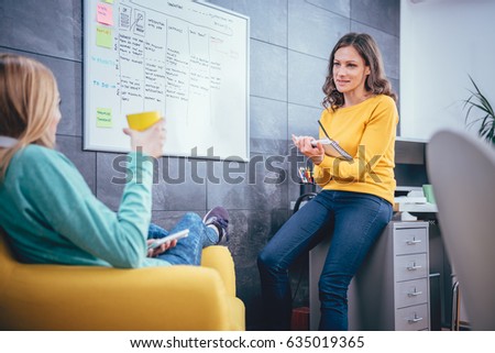 Two business woman having meeting in front of the whiteboard