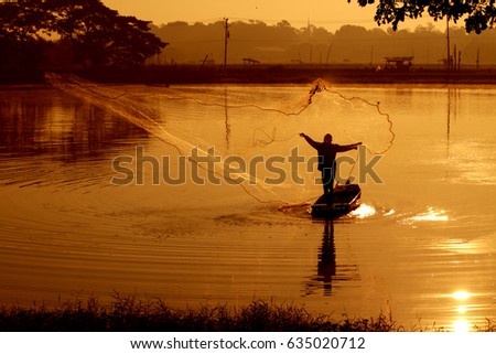 Fisherman fishing on sunset in the pond, Thailand