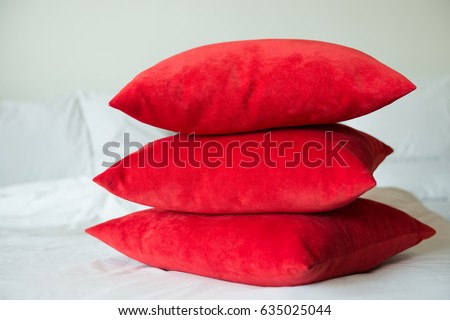 Red pillows on a white bed Royalty-Free Stock Photo #635025044
