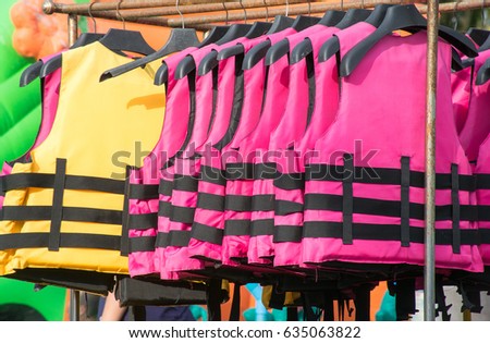 Soft focused picture of Multiple colour of Life jacket are hanging on Clothesline
