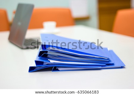 file folder with documents and Notebook background on white table in meeting room 