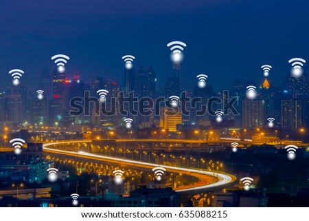 Wifi network connection concept on aerial view of cityscape business district at twilight background.