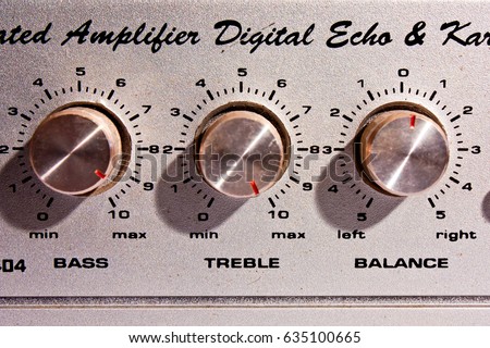 Golden Knobs from the front of an amplifier/Detail of sound volume controls Royalty-Free Stock Photo #635100665