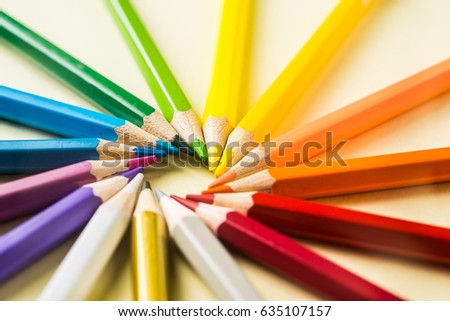 Business concept - Top view of color pencil circle on yellow paper background, teamwork, united and communication concept