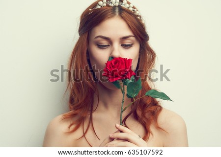 Woman sniffing a rose