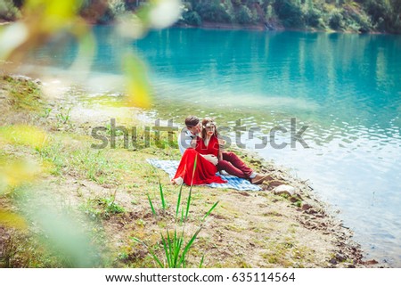 Gorgeous mermaid in flowers wreath from the lake in the woods calling man to go with her into the water. Fantasy magic concept