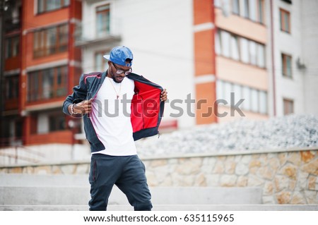 Portrait of stylish african american man on sportswear, cap and glasses. Black men model street fashion. Royalty-Free Stock Photo #635115965