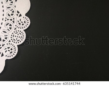 black background with lace and space for your text. paper lace on black background