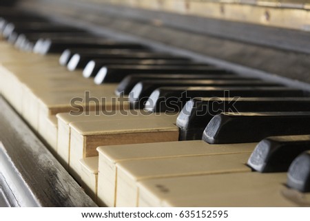 Old piano keyboard with broken keys