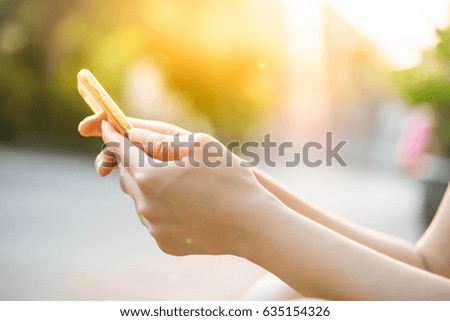 Close-up hand of asian woman using smart phone, high key