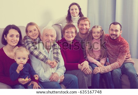 Positive family making numerous photos during family dinner