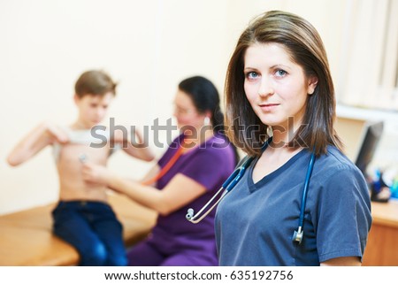 female children's doctor in front of pediatrician little boy examination