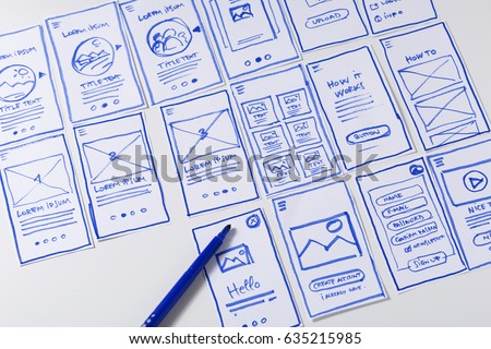 User experience design, desk with paper sketches for mobile interface Royalty-Free Stock Photo #635215985