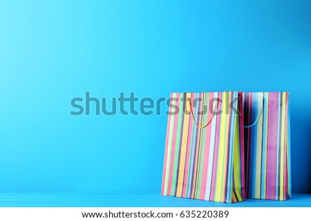 Colorful shopping bag on blue wooden table