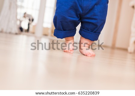 Baby legs. First steps. Royalty-Free Stock Photo #635220839