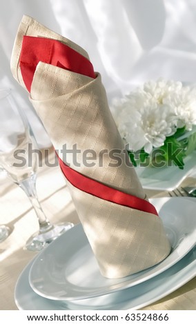 Coordinated decorative napkin on a plate with cutlery