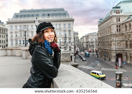 Young Asian woman tourist on the street in the center of Vienna smiling at winter
