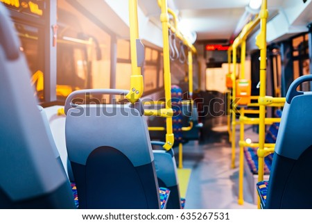 Modern city bus interior and seats. Public transport Royalty-Free Stock Photo #635267531