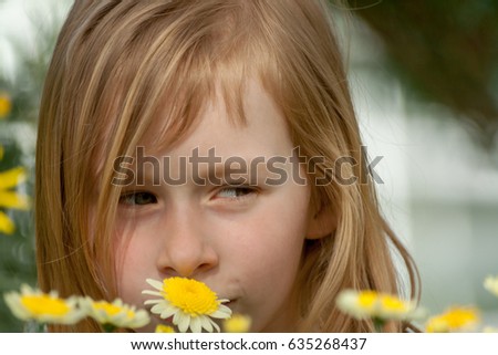  portrait little girl seven years old, sniffing daisy flowers in botanical garden, eyes open, looking at right side, very cunning eyes, peeping, long wheat hair, chamomile, happy baby,sunny bright day