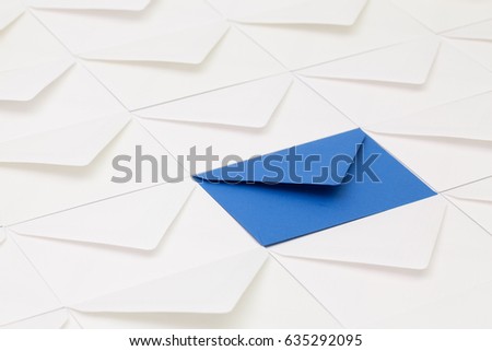 Composition with white envelopes and one dark blue  envelope on the table.