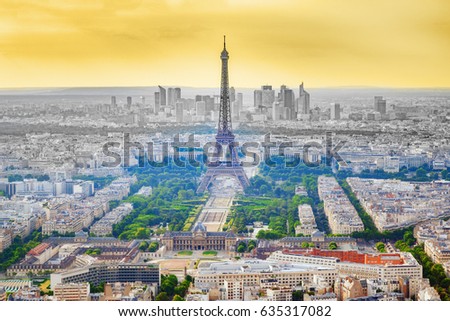 Aerial view at Paris city quarters and Eiffel tower from roof of Montparnasse skyscraper , sunset scenery and dramatic yellow sky at background.