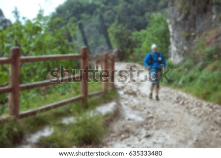 Picture blurred for background abstract and can be illustration Blurred background athletes running around the muddy track during the Trail Marathon