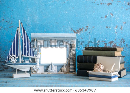 Sea theme decorations. Decorative photo and marine items on wooden background. 