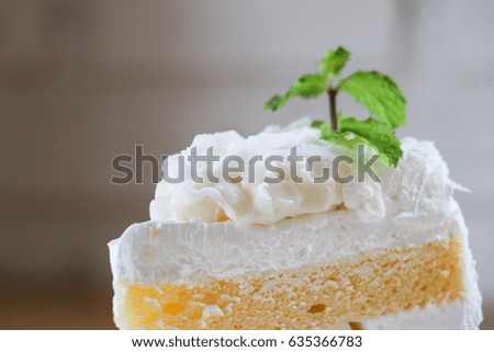 Closeup Piece of coconut cake on wooden table. selective focus.