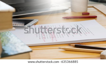 proofreading text on table in office Royalty-Free Stock Photo #635366885