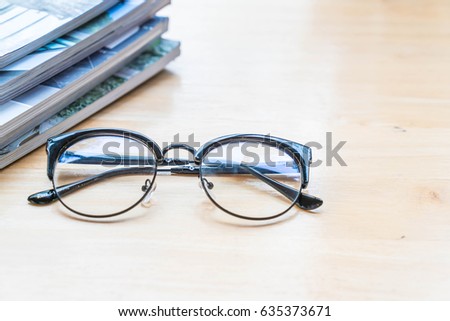 glasses with book or magazine