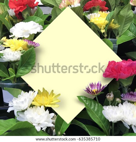Creative nature layout made of tropical leaves and flowers with paper card note