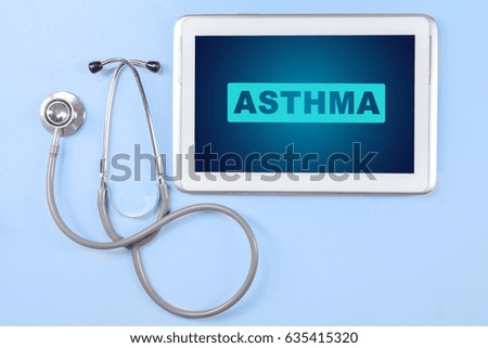 High angle view of a stethoscope with asthma word on the digital tablet screen on the blue background