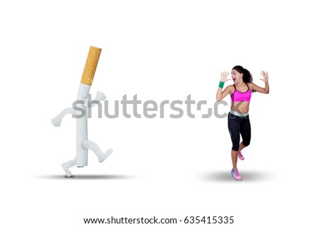 Picture of young Indian woman chased with a cigarette while running in the studio