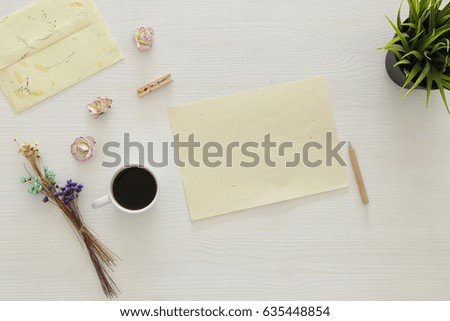 vintage mockup with flowers, cup of coffee and blank letter white on wooden background
