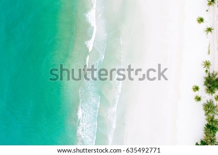 Top view of beautiful white sand beach with turquoise sea water and palm trees, aerial drone shot Royalty-Free Stock Photo #635492771