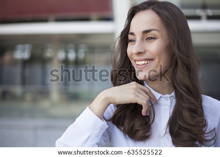 Successful modern business woman looking confident and smiling.