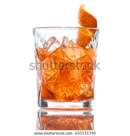 Alcoholic cocktail of the Godfather with orange peel and ice, isolated on white background Royalty-Free Stock Photo #635531390