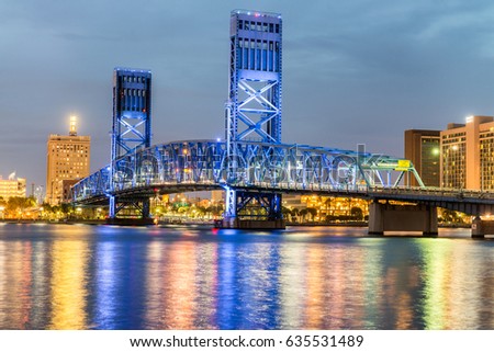 Jacksonville, Florida. City lights at night with bridge and river reflections.