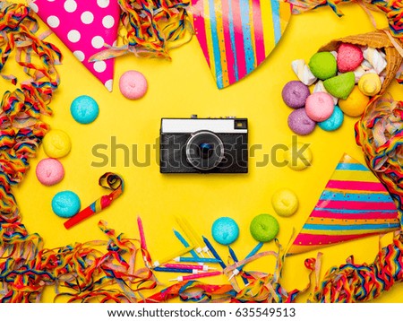 photo of  retro camera and wonderful event decorations on the beautiful yellow studio background