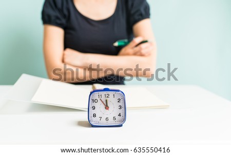 Studying woman and clock Royalty-Free Stock Photo #635550416
