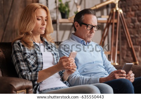 Ignorant couple using cellphones at home Royalty-Free Stock Photo #635550443