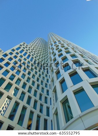 macro photo with an architectural background of a modern building in a European city, white decorative skyscraper on blue sky background, as the source for design, advertising, decoration, print, 
